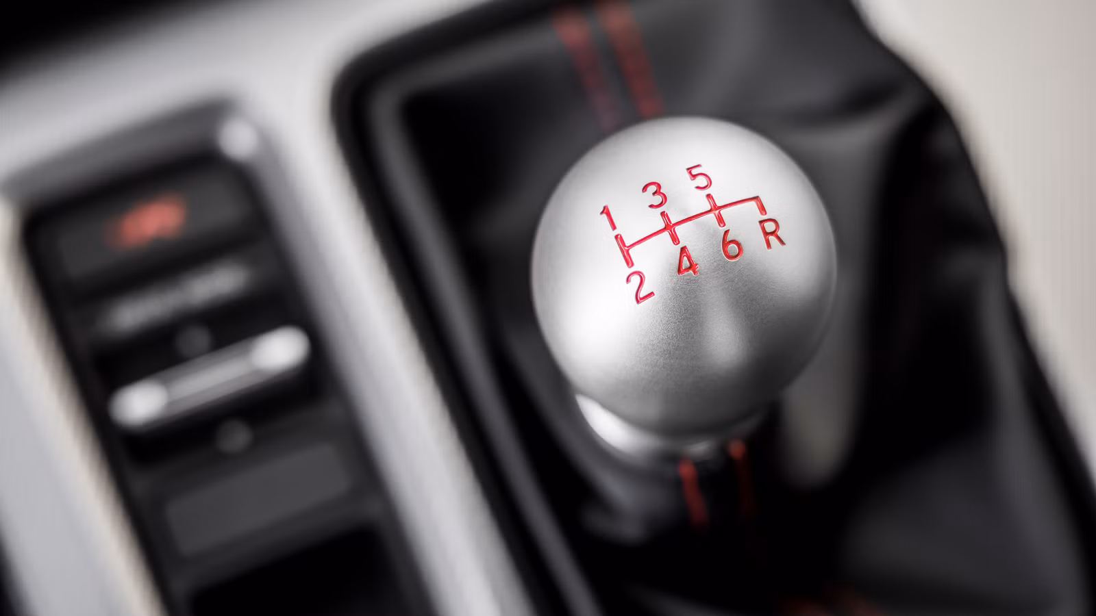 Close-up of a six-speed manual gear shifter in a car interior